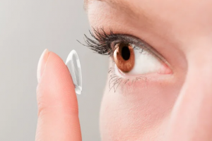 female putting in contact lens