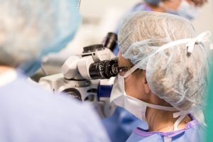 employee using microscopic tool for operation