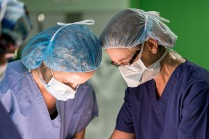 two employees staring down in concentration during operation